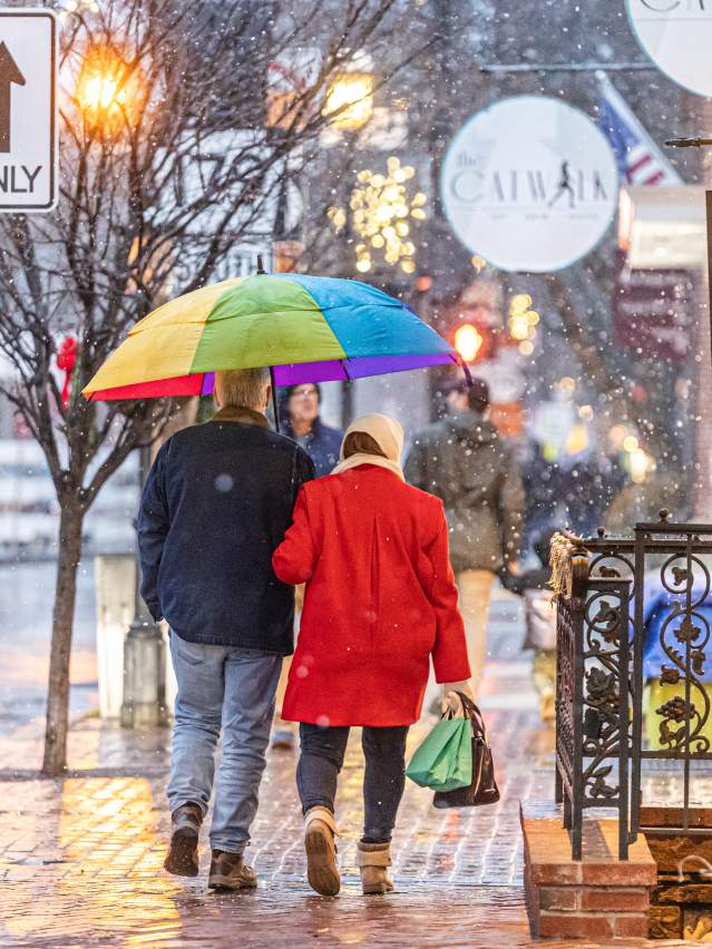 People Walking Down A Rainy New Hope Street