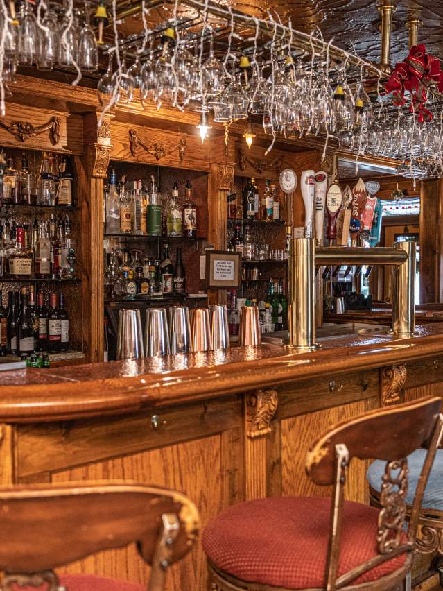 Antique wooden bar with artistic carved wood details and vintage charm