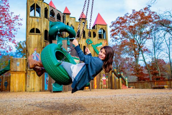 Children enjoy the tire swing, one of many attractions at the Kids Castle in Doylestown.