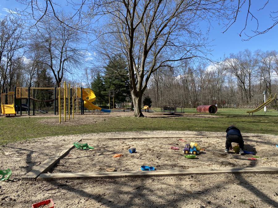 Kids Playing In A Sandbox At Covered Bridge Park New Britain