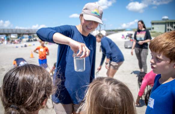 Park staff educating children on the ocean water.