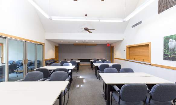 Ashley Center Indoor Facility set up like a meeting room with tables and chairs.