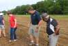 Tamping down soil after seeds have been planted.