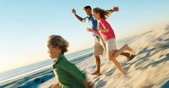 family running on beach