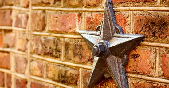 old bronze star attached to a brick wall