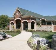 A path lined with plants leads to the entrance of the Drees Pavillion.