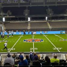 An arena football team practices at an indoor space.