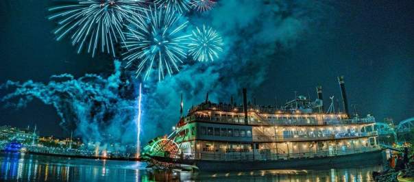 The image is of the BB Riverboat at night with fireworks in the background.