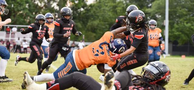A player performs a leaping tackle