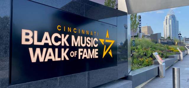 A black marble sign that says Cincinnati Black Music Walk of Fame