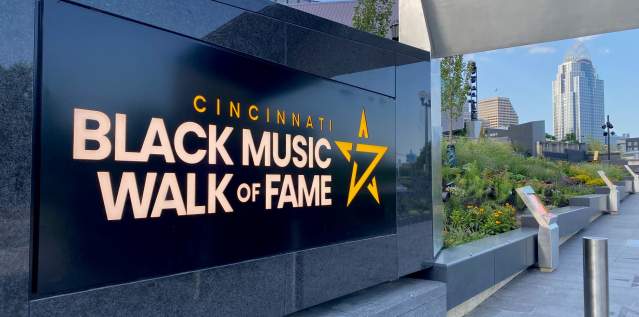 A black marble sign that says Cincinnati Black Music Walk of Fame