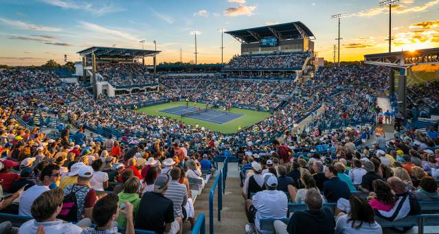 A packed arena of fans looks down at a tennis court at the Cincinnati Open