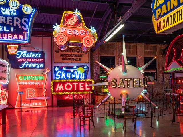 Several neon signs on display at the American Sign Museum