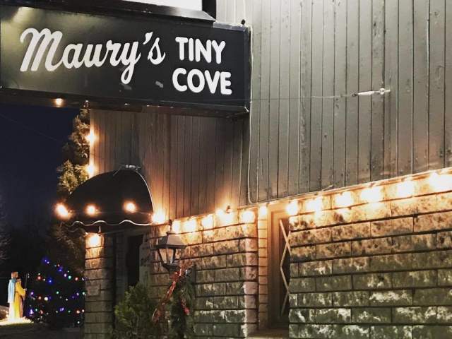 Image of the outside front door of Maury's Tiney Cove with the sign above the door that says "Maury's Tiny Cove".