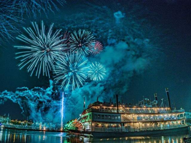 The image is of the BB Riverboat at night with fireworks in the background.