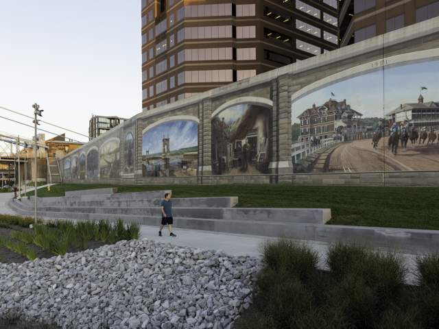 A person walks along the floodwall murals in Covington, KY.