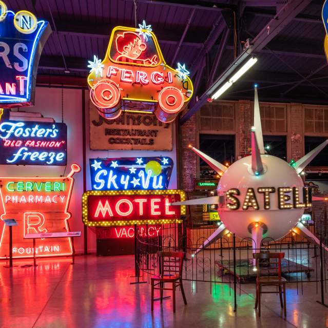 Several neon signs on display at the American Sign Museum