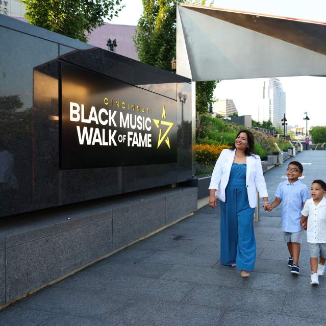 A family walks through the entrance of the Cincinnati Black Music Walk of Fame