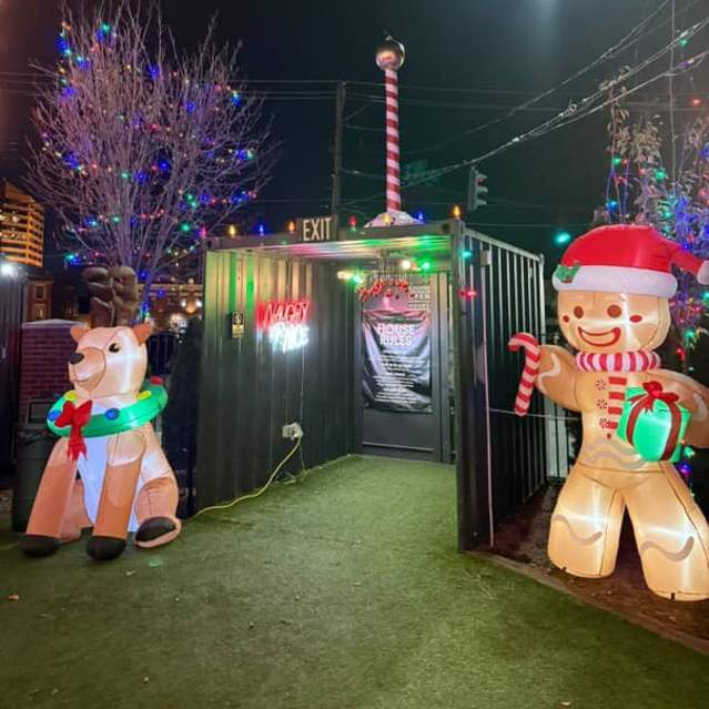 The festive entrance, guarded by 2 inflatable gingerbread men, to Covington Yard's Winter Wonderyard pop-up