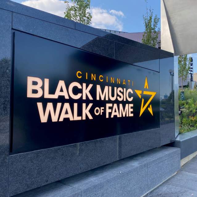 A black marble sign that says Cincinnati Black Music Walk of Fame