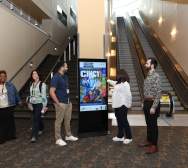 Conference attendees use an interactive kiosk.