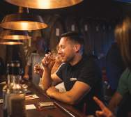 man drinking bourbon at prohibition bourbon bar in newport ky