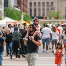 Dad walking with his daughters at Asian Food Fest