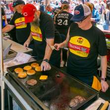 A crew at Taste of Cincinnati grill up some cheeseburgers.