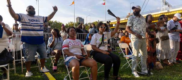 A group of people sitting and standing at Sawyer Point, celebrating the Black Family Reunion