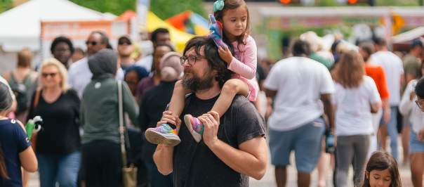 Dad walking with his daughters at Asian Food Fest