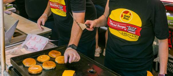 A crew at Taste of Cincinnati grill up some cheeseburgers.