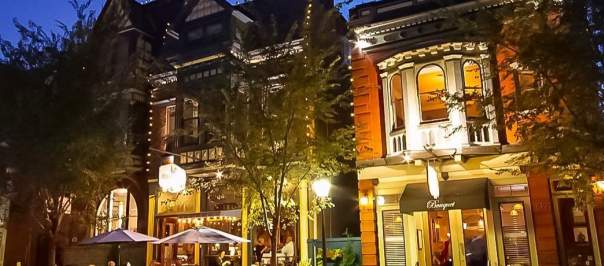 19th century buildings in Mainstrasse Village in Covington, Ky. illuminated by strings of lights and street lights.