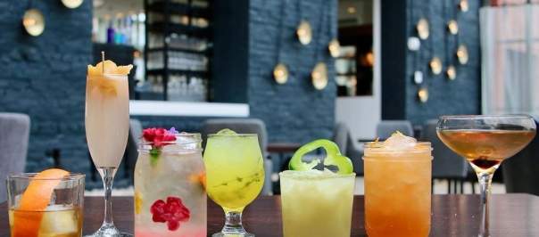 A row of various cocktails, colored pink, yellow, amber and green at Coppin's Restaurant in Covington, Ky.