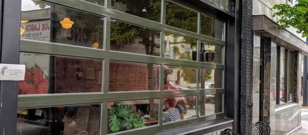 black patio chairs on sidewalk outside of the baker's table restaurant in newport ky