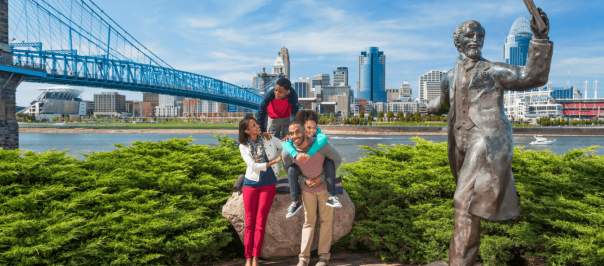 family posing on the Cincinnati waterfront