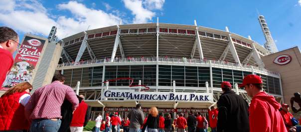Groups of people walk away from the camera towards the entrance to Great American Ball Park.