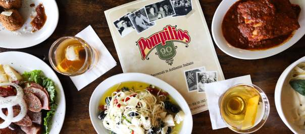 Pompilios menu surrounded by various cocktails, appetizers, and entrees.