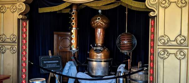 A still shaped like a fortune teller, under a gold theater awning at Second Sight Spirits
