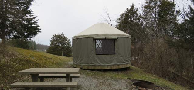 photo of a yurt, fire pit, and picnic table at aj jolly park in Alexandria ky