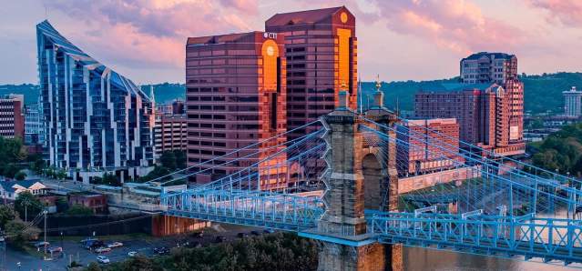 The skyscrapers, The Ascent and Rivercenter Towers behind the Roebling Bridge and Ohio river on a sunny day