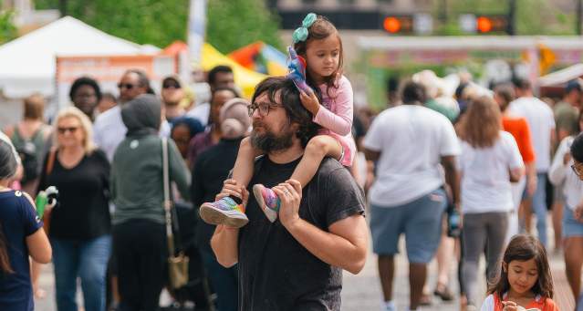 Dad walking with his daughters at Asian Food Fest