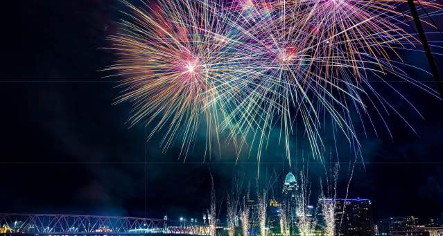 Image is of fireworks over the Ohio River with the City of Cincinnati in the background.