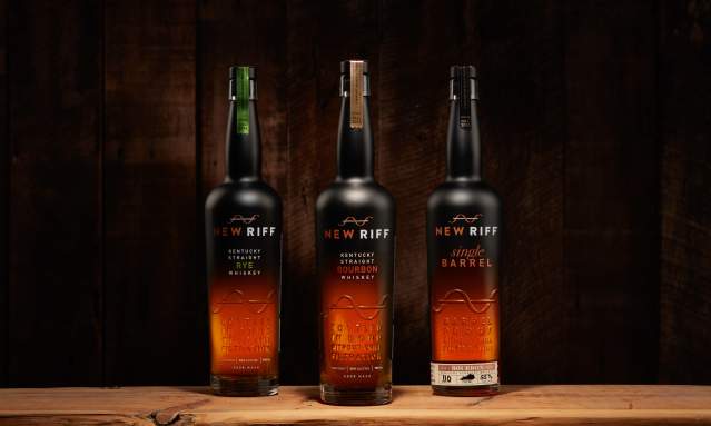 Three bottles of New Riff bourbon sit on a wooden table.