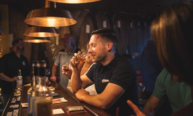 man drinking bourbon at prohibition bourbon bar in newport ky