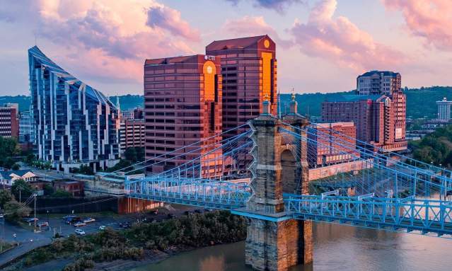 The skyscrapers, The Ascent and Rivercenter Towers behind the Roebling Bridge and Ohio river on a sunny day