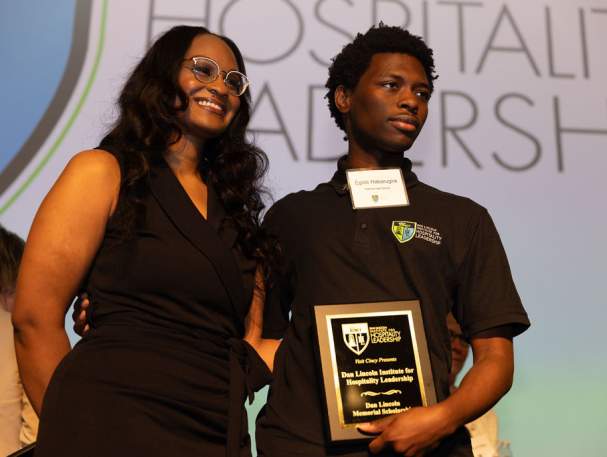 IHL instructor with a graduating student holding an award