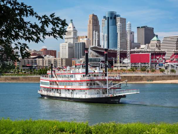 photo of a paddlewheel riverboat from bb riverboats in newport kentucky with the cincinnati oh skyline in the background