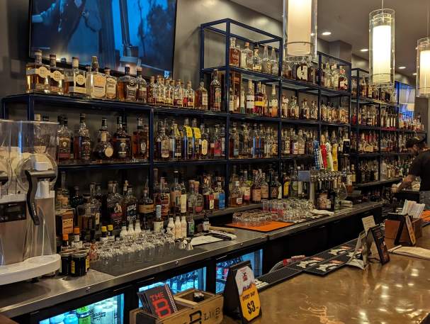 Hundreds of bottles line the shelves behind the bar at The Globe