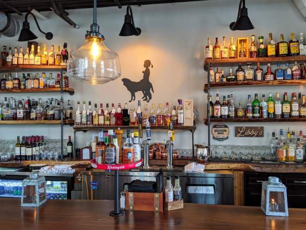 A wall at Libby's Southern Comfort restaurant in Covington, KY, displaying their large collection of bourbon.