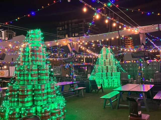 Lit up Christmas trees made of beer barrels at Covington Yard's Winter Wonderyard